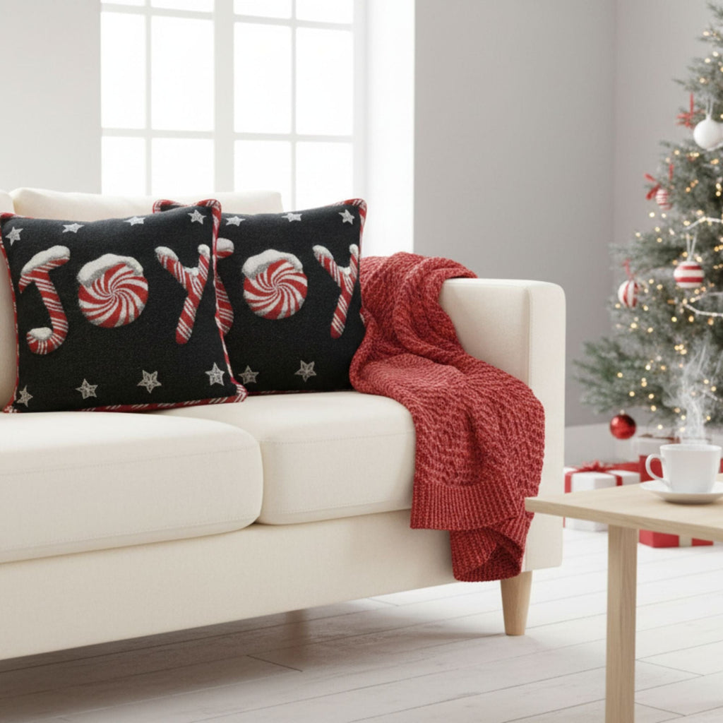 Black throw pillow cover with peppermint swirls, candy canes, and white stars