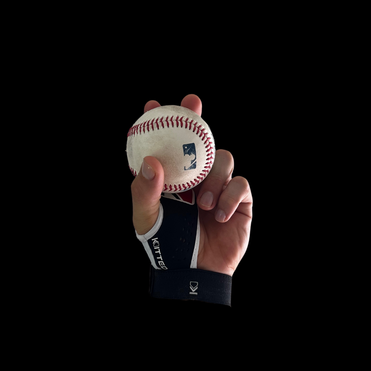 Baseball spin-grip training glove holding a baseball at close range