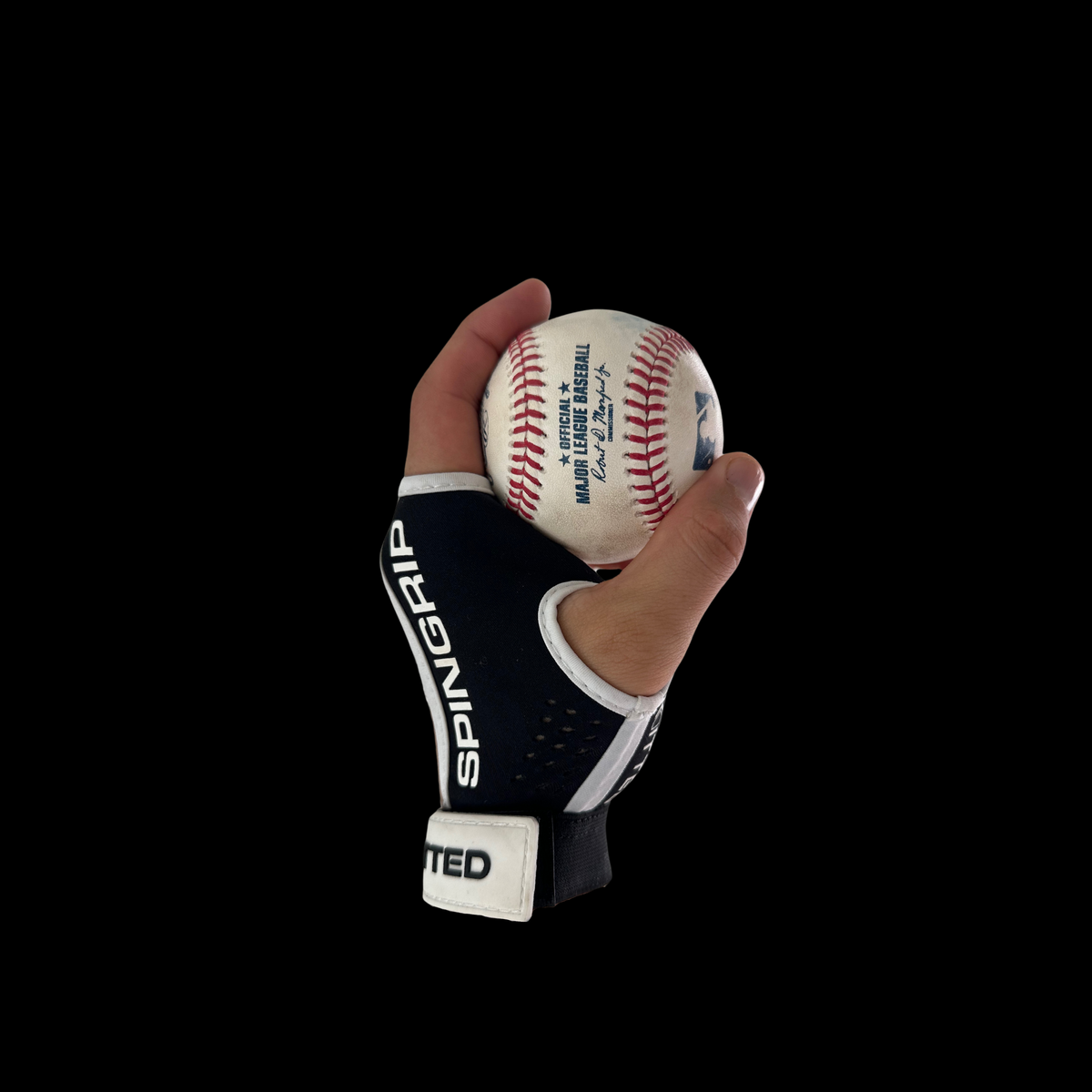 Black spin-grip training glove holding a white baseball with red stitches