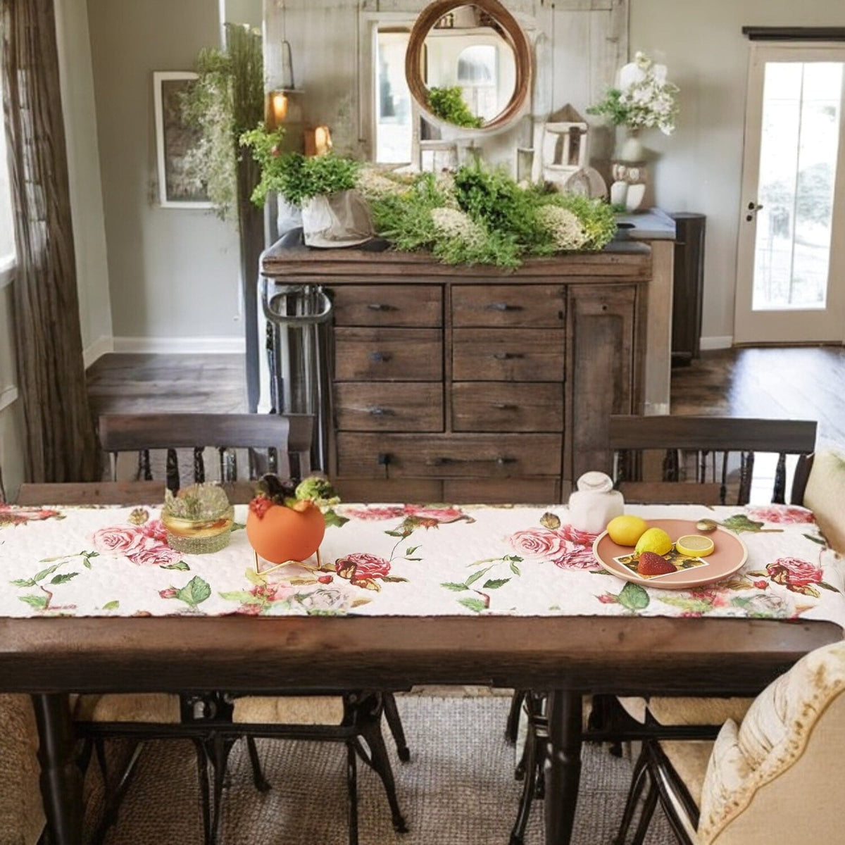 White quilted dining table runner with scattered pink roses and leafy accents.