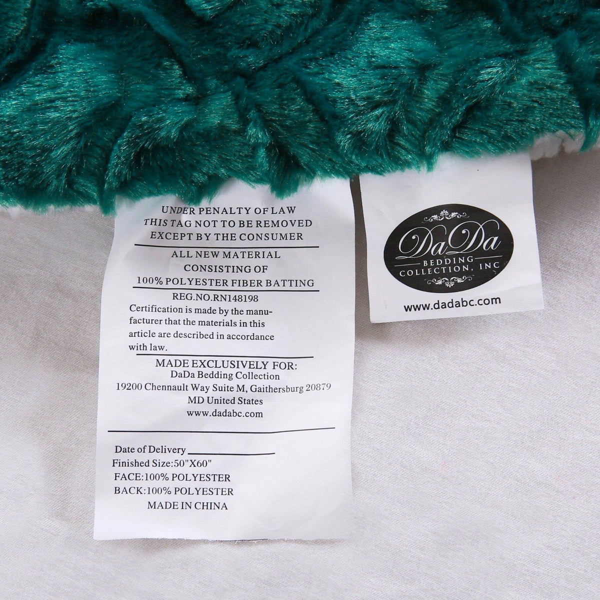 DaDa bedding throw blanket care label on white sherpa backing