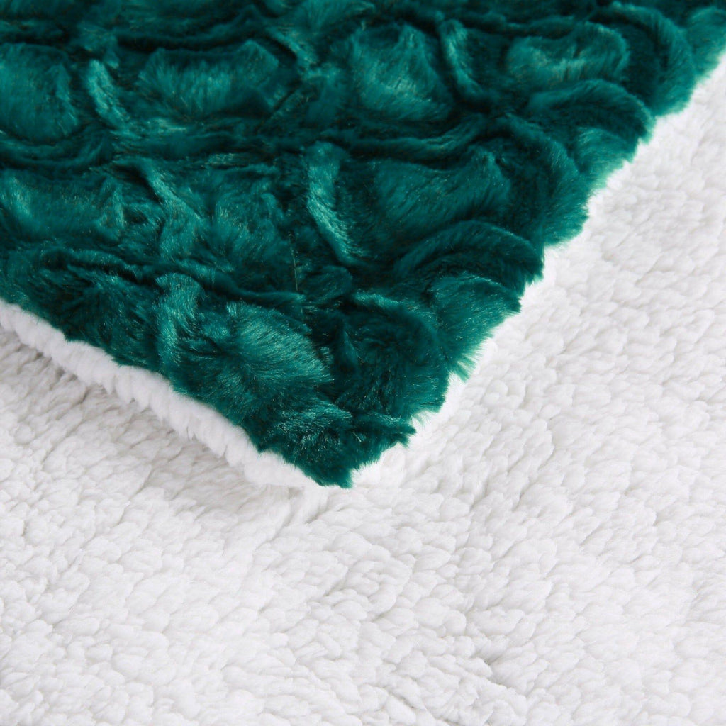 Emerald green faux fur edge with white sherpa backing on a throw blanket