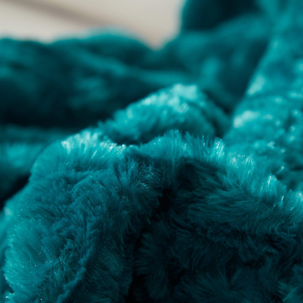 Faux fur sherpa throw blanket in deep teal with thick, textured pile close-up