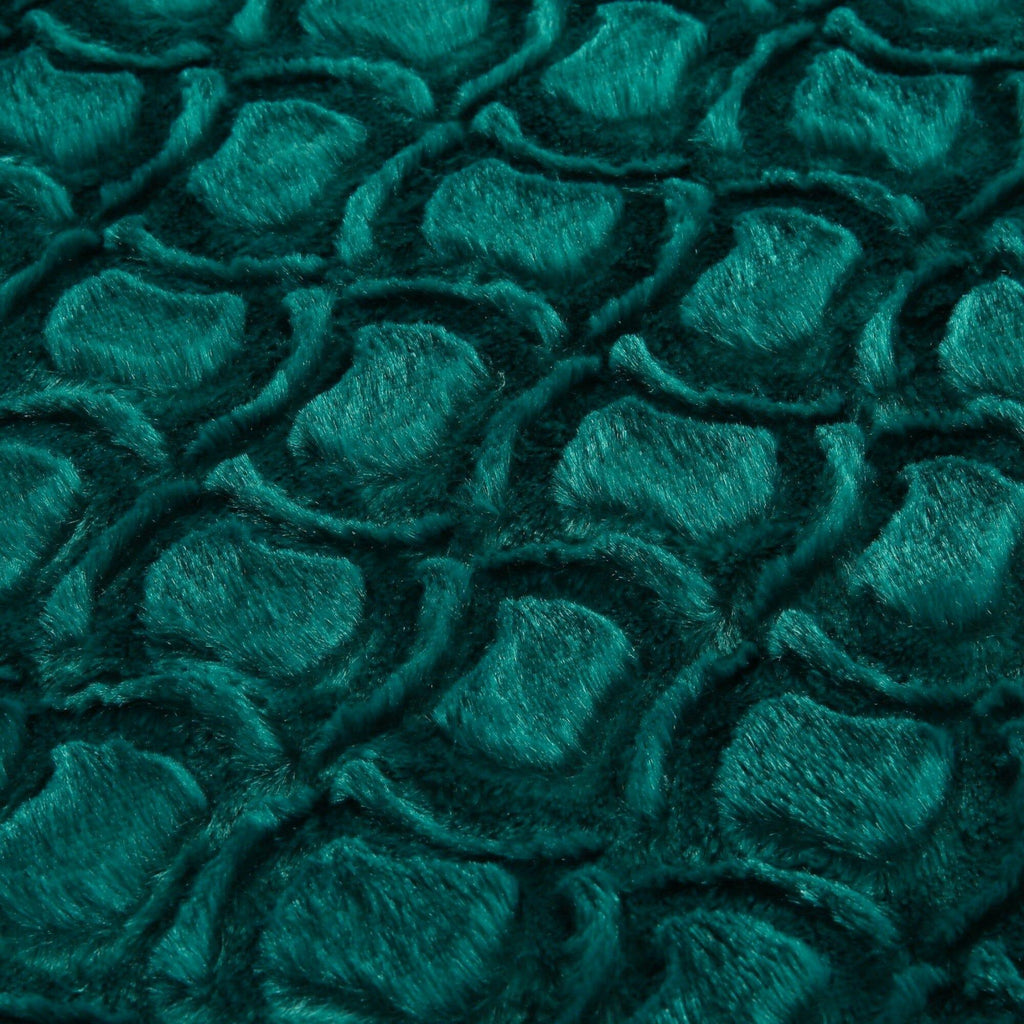 Emerald green faux fur sherpa throw blanket surface with swirling plush pattern