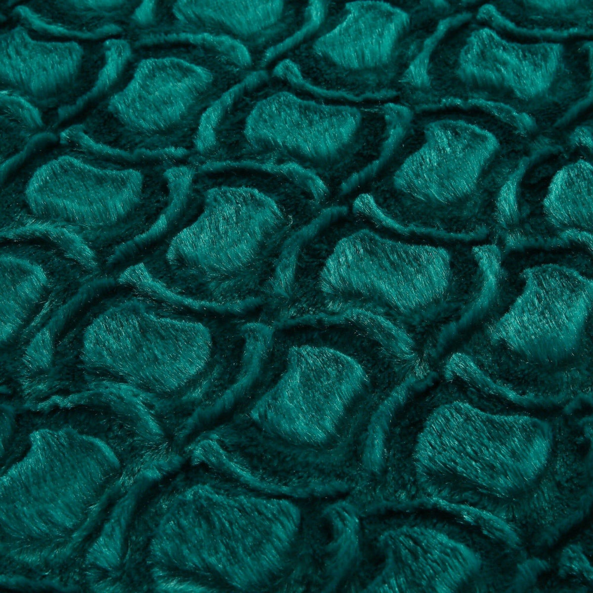 Emerald green faux fur sherpa throw blanket surface with swirling plush pattern