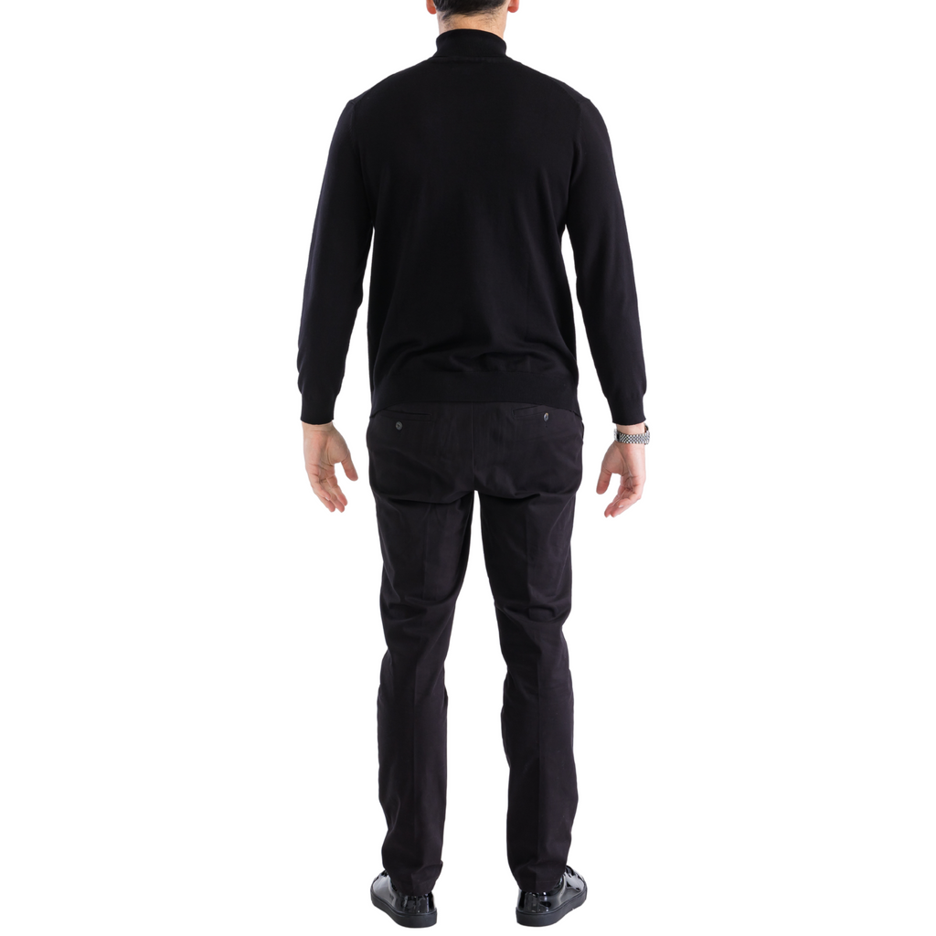 Men's black pullover turtleneck sweater, back view with ribbed cuffs
