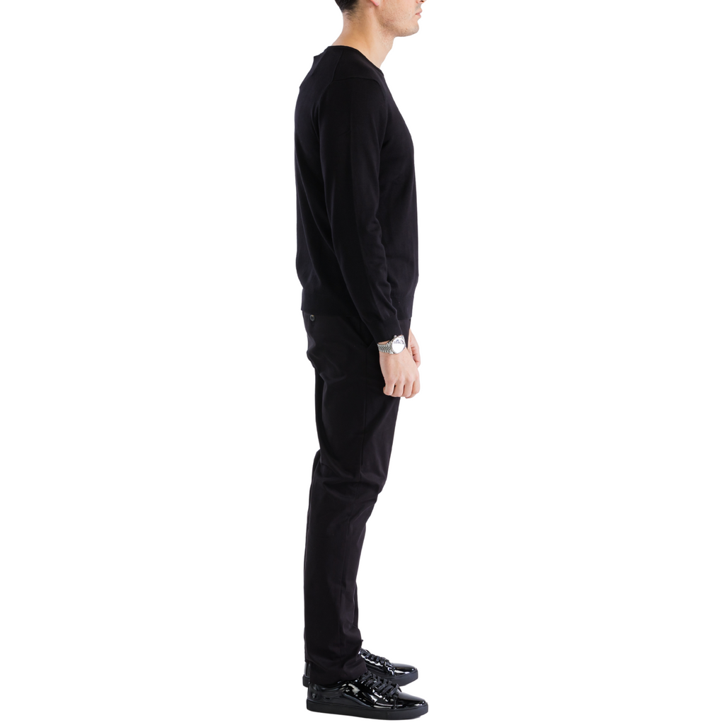 Men's black crewneck knitted pullover sweater, side profile view, long sleeve