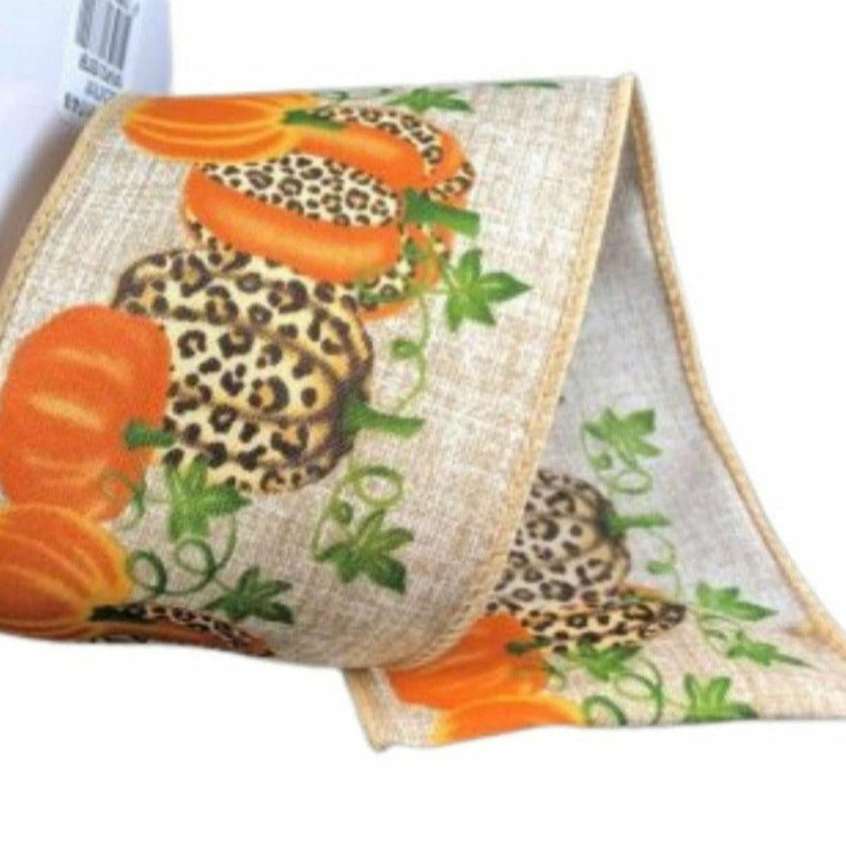 Natural linen ribbon detail: orange pumpkins, cheetah faces, and green leaves on beige