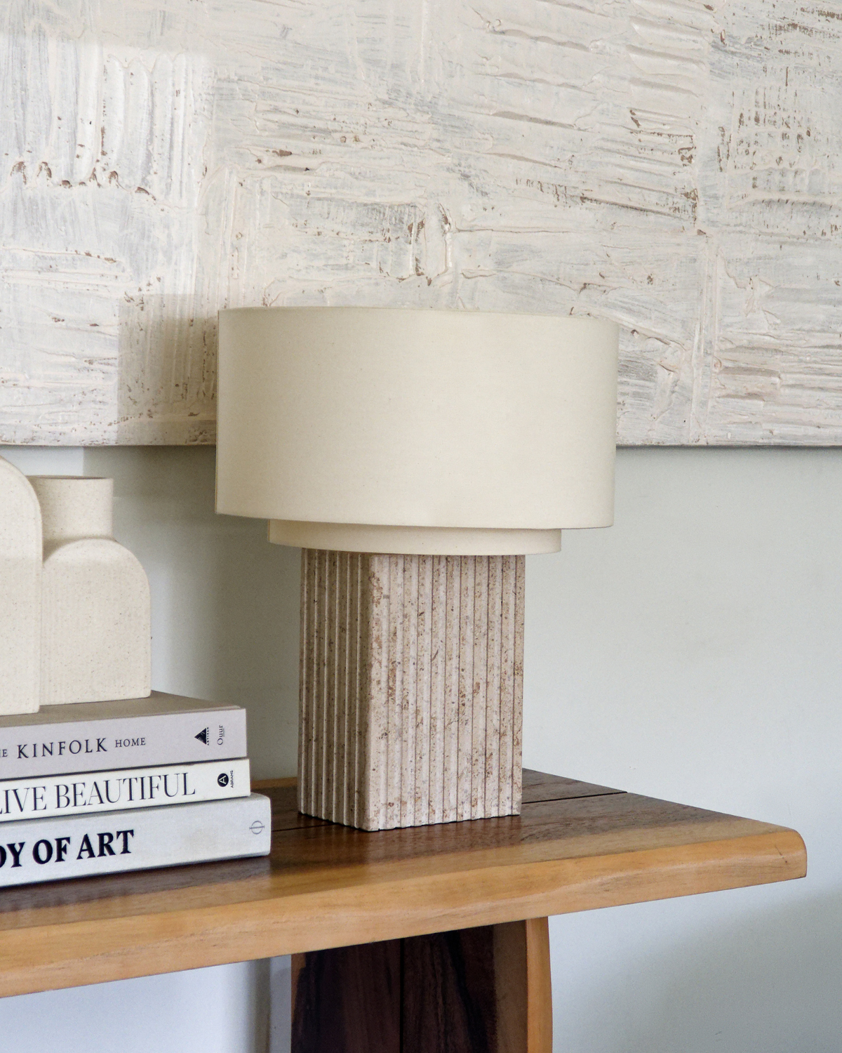 Table lamp with off-white drum shade and ribbed tan ceramic base