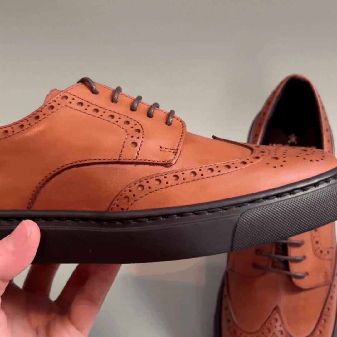 Women's cognac leather lace-up oxford with perforated brogue details and dark rubber sole