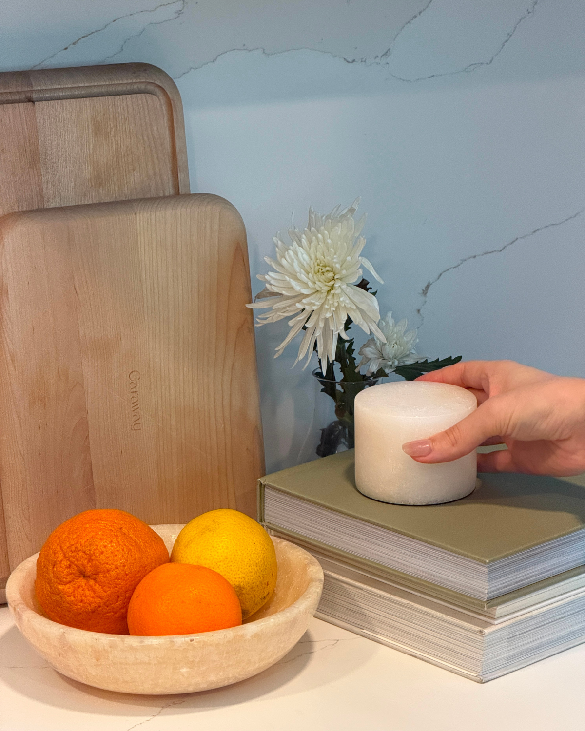 Cylindrical portable lamp with warm glow, hand pressing on table