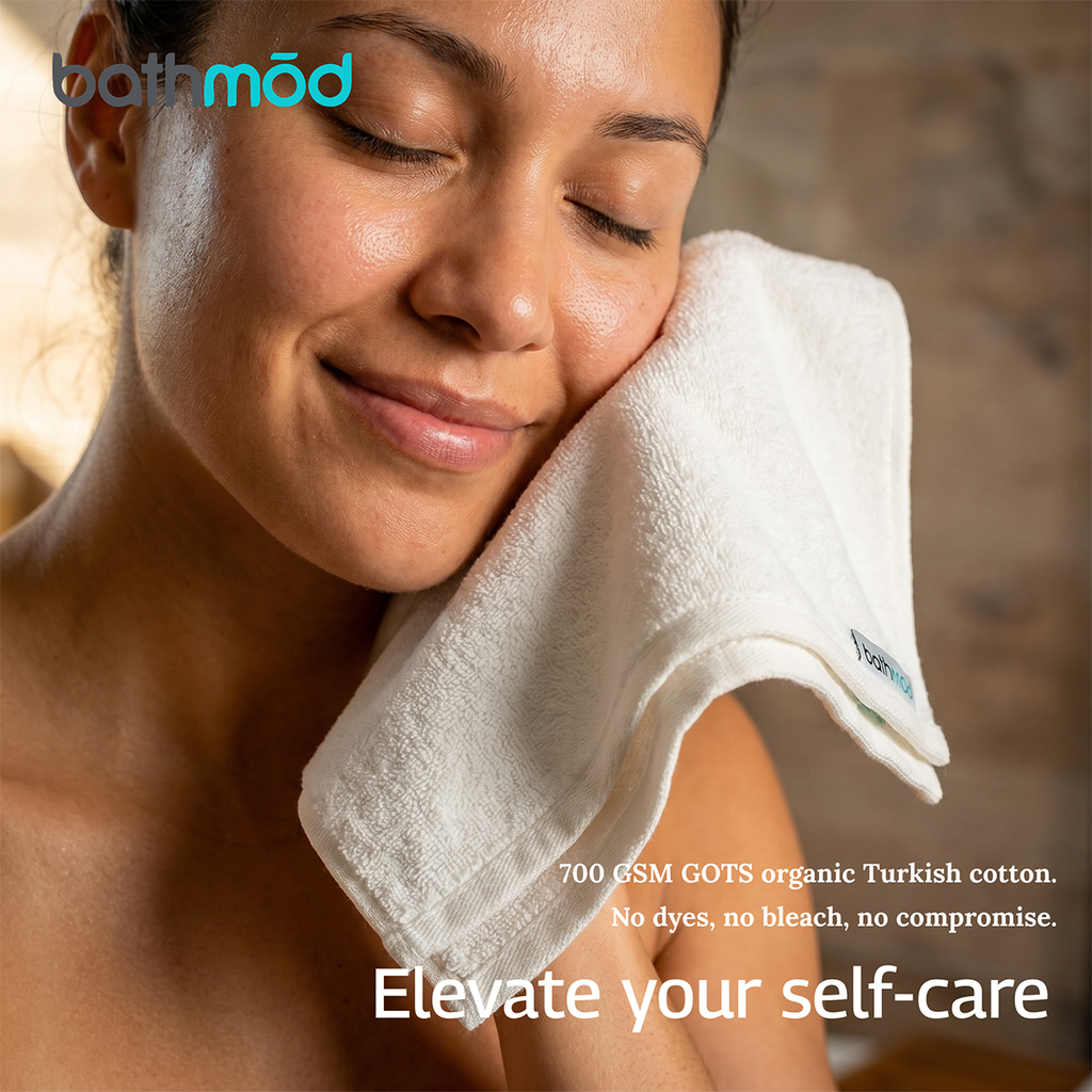 Person wearing a white plush towel over one shoulder, soft bath towel set