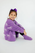Purple plush cardigan for girls with bow pattern, open front and long sleeves.