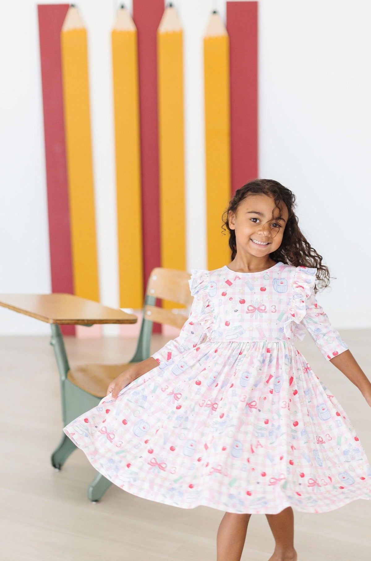 White printed 3/4 sleeve ruffle twirl dress with gathered skirt and colorful motifs
