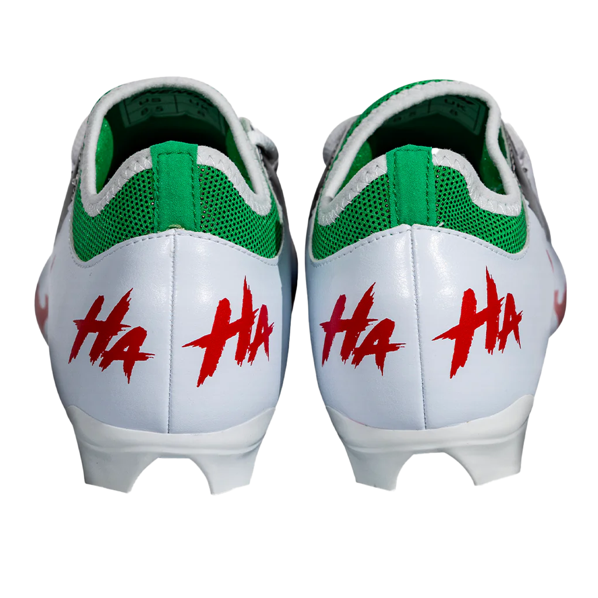 Pair of white-and-green cleats with red HA markings on heel and back