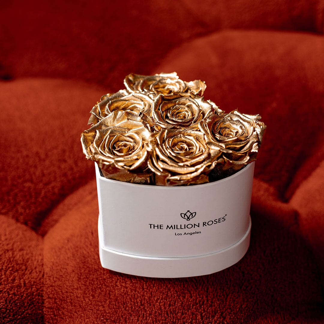 White round gift box of gold roses; THE MILLION ROSES logo on the front