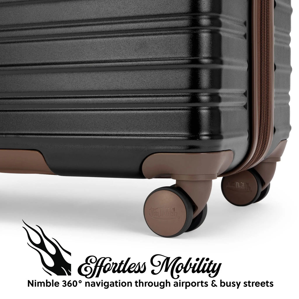 Bottom view of dark hardside spinner luggage with four wheels and tan protective base