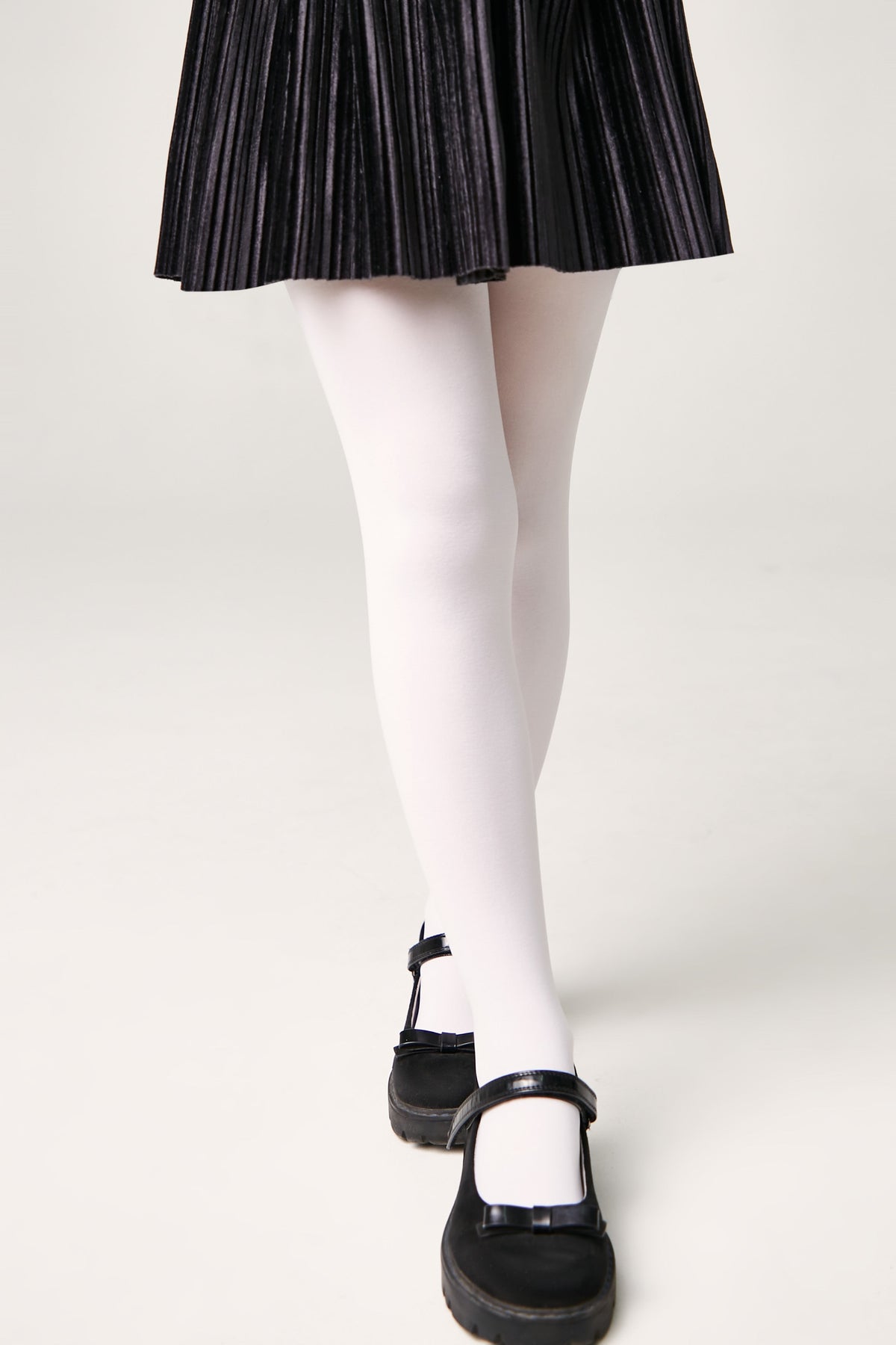 Girls 60 den velour tights in light color, lower leg view to the shoes