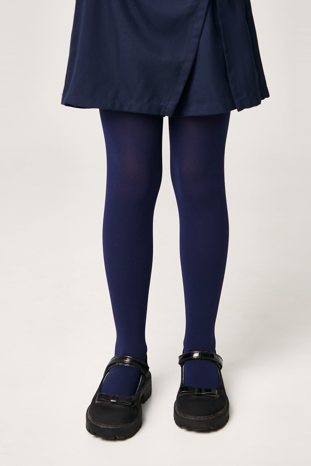 Girls 60 den velour tights in deep navy, leg view with smooth velour texture