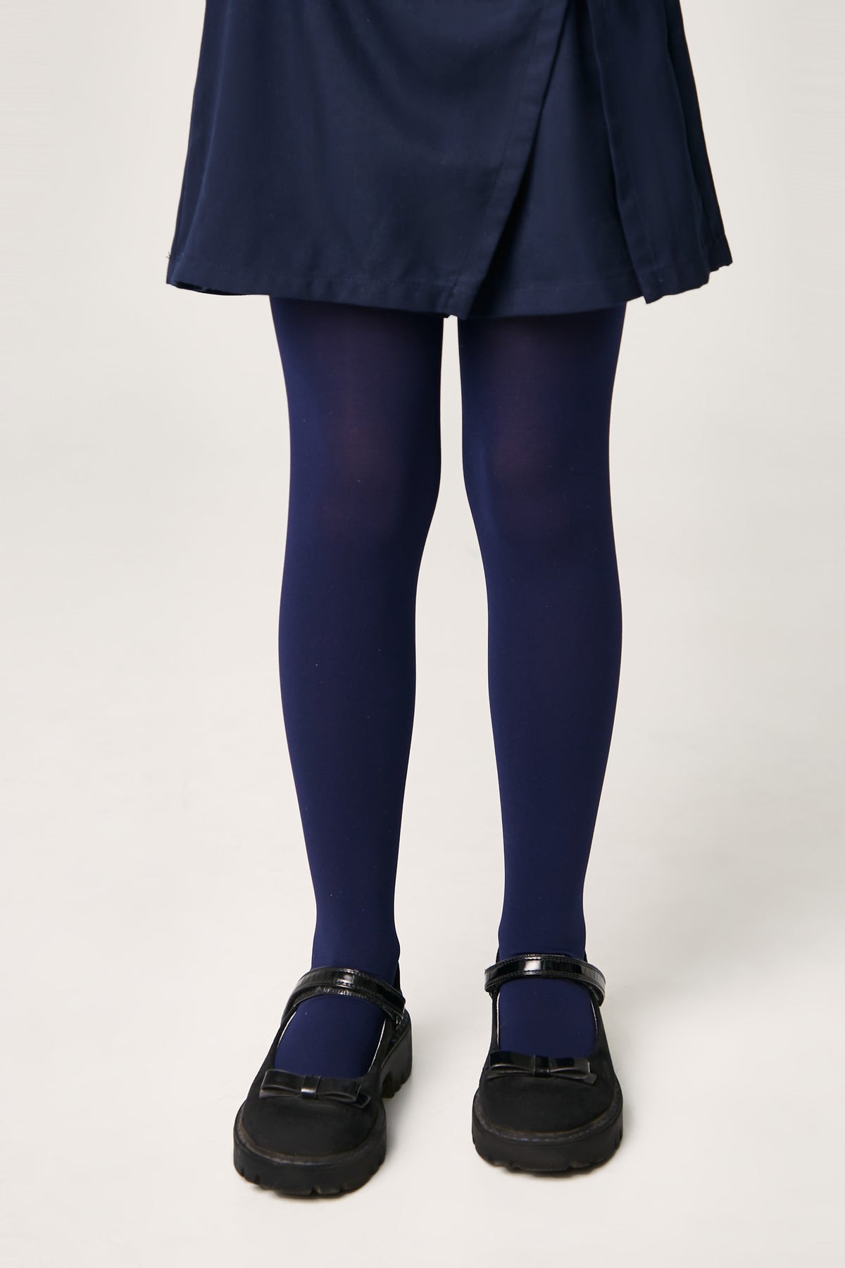 Girls 60 den velour tights in deep navy, leg view with smooth velour texture