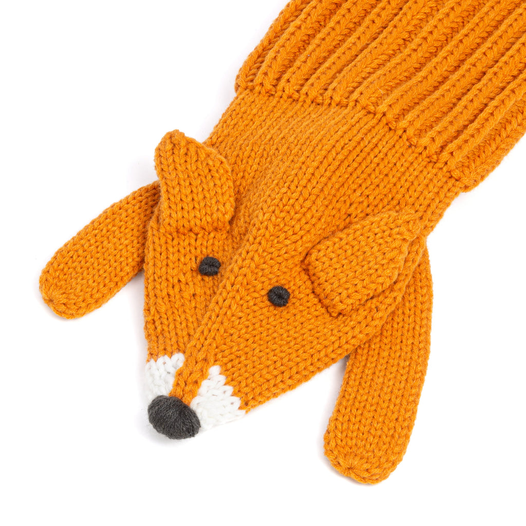 Orange fox-shaped knitted scarf with curled tail, button eyes, and stitched paws