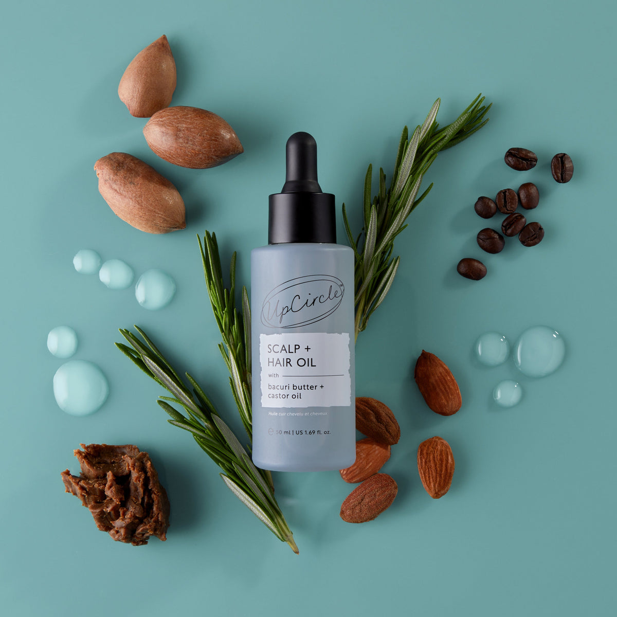 Scalp + hair oil bottle with bacuri butter, castor seeds, and oil drops