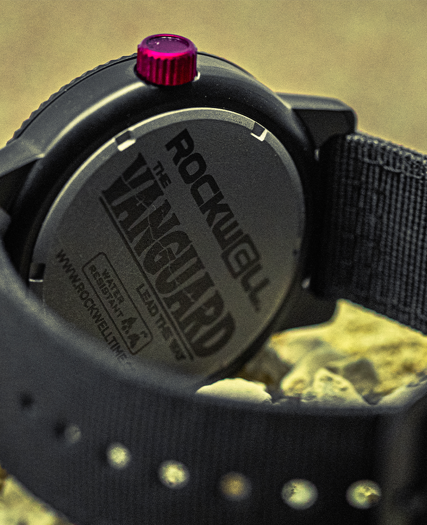 Vanguard black watch close-up of black case back with red crown