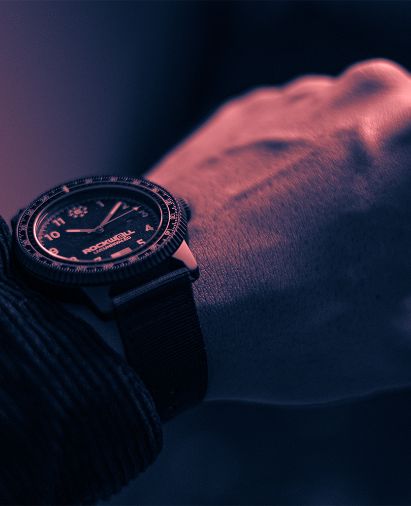 Vanguard black watch on wrist with black textile strap and dark dial