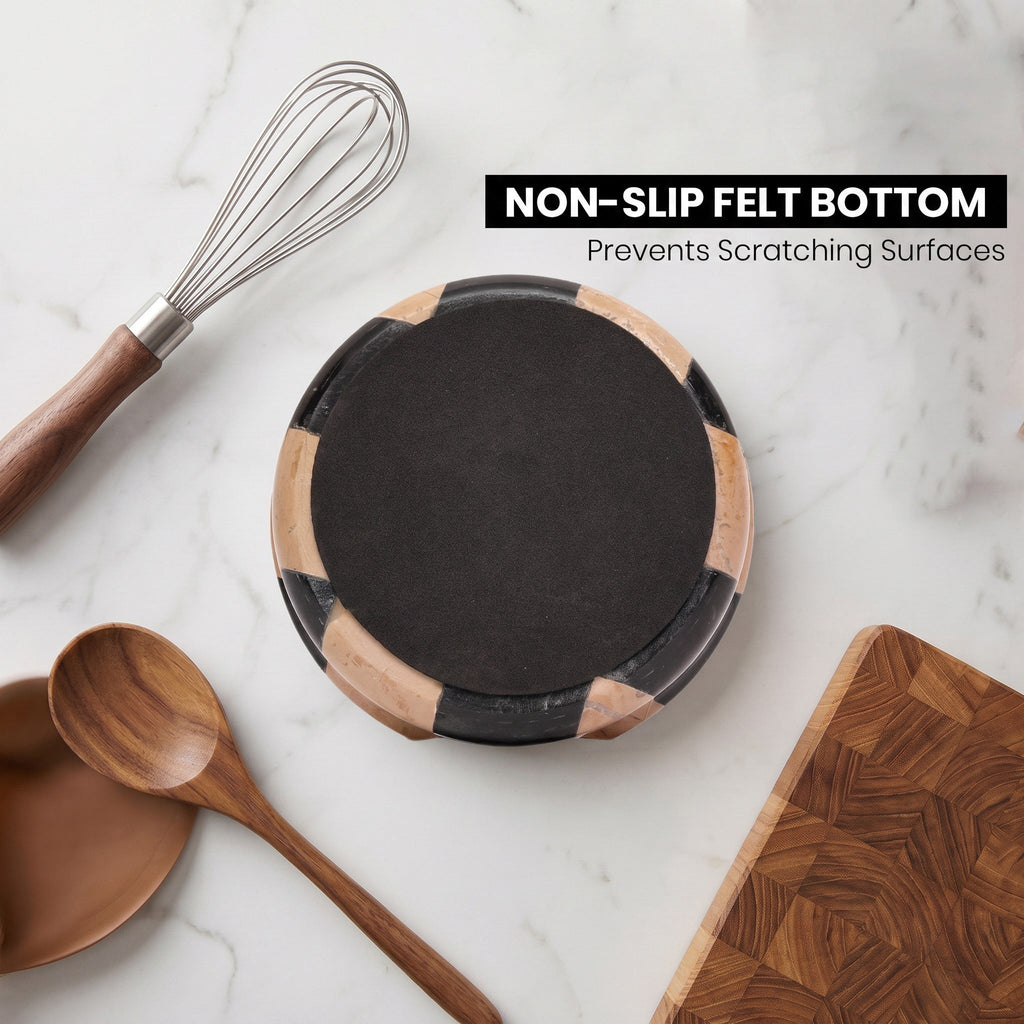 Round marble spoon rest with black felt bottom and black-and-cream checkered sides