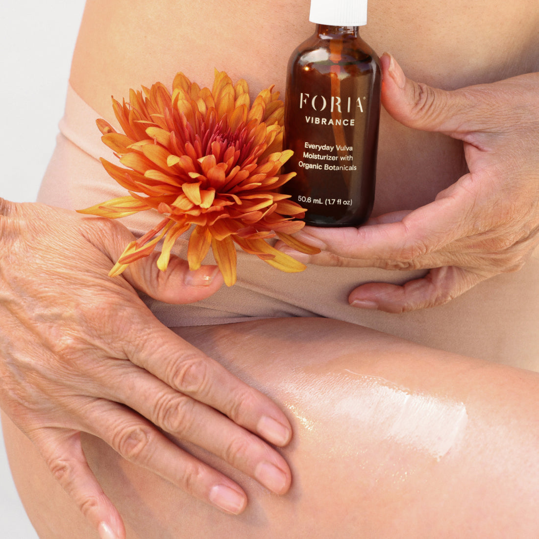 FORIA vulva moisturizer applied by hands from a pump bottle on skin