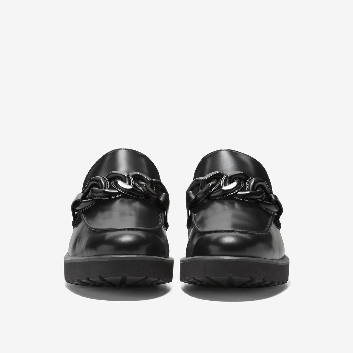 Black Cole Haan chain loafer, back view with metal ring detail and tread sole