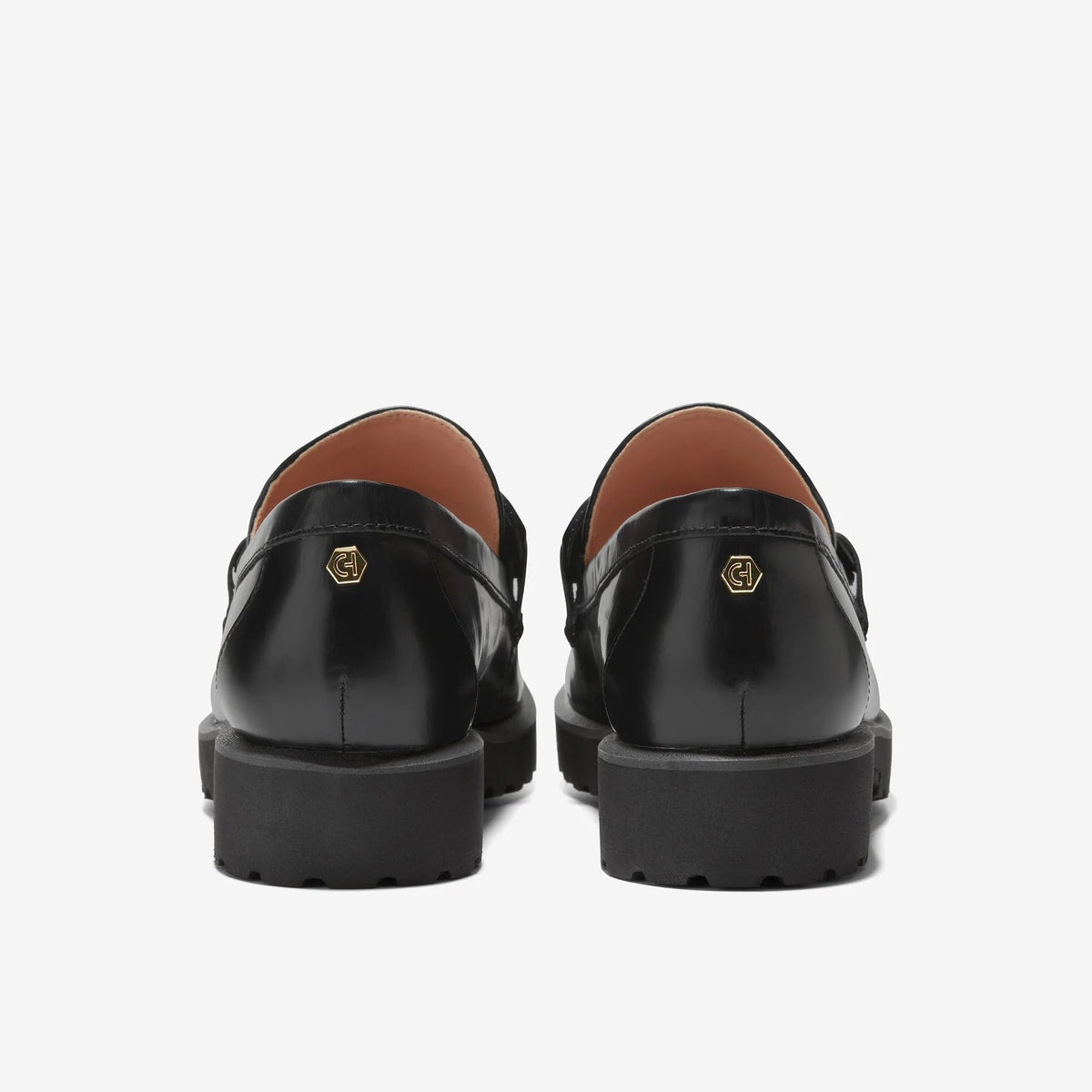 Black Cole Haan chain loafer, heel and logo plate with stacked platform
