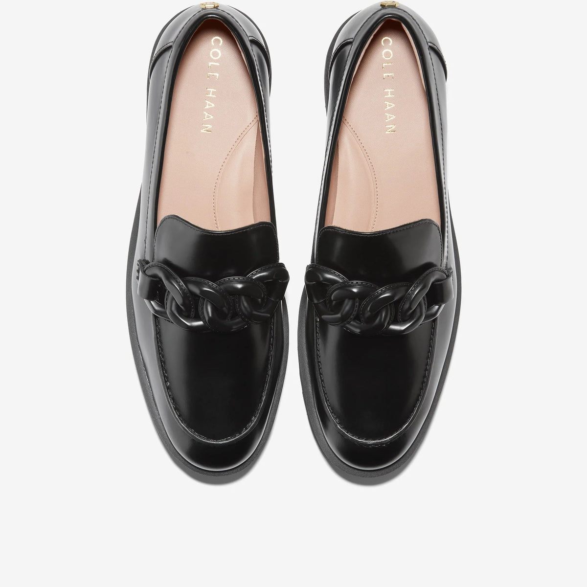 Black Cole Haan chain loafer with tan insole, glossy finish, metal chain detail