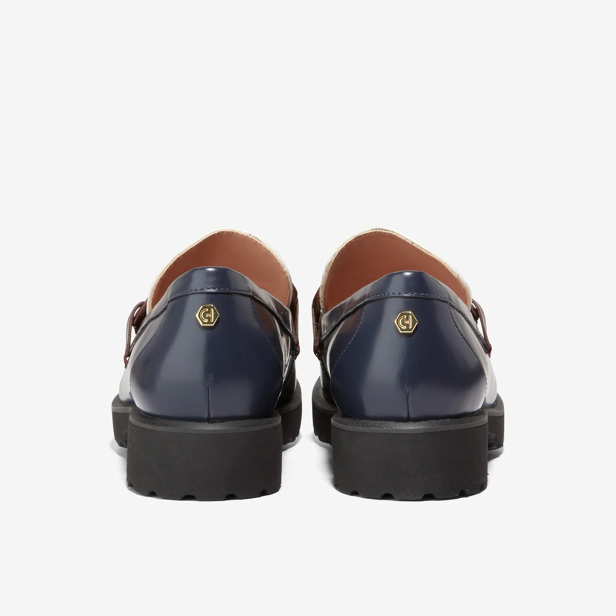 Women's loafer backs: navy leather with burgundy chain, dark outsole, tan interior lining