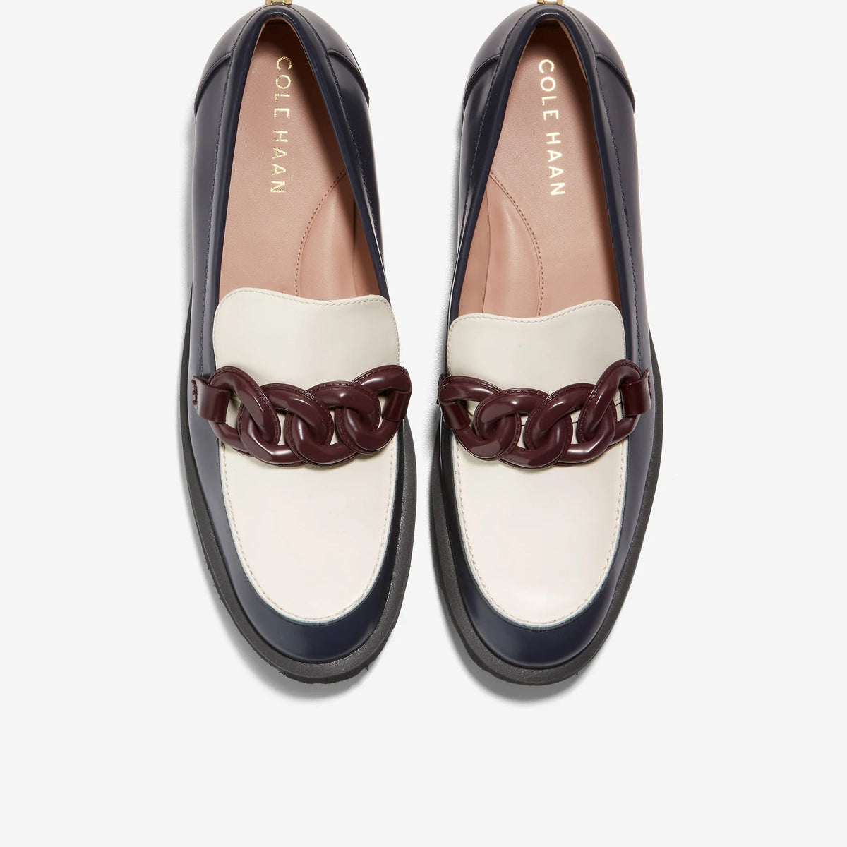 Women's loafers with white-and-navy panels and burgundy chain ornament, moc-toe style