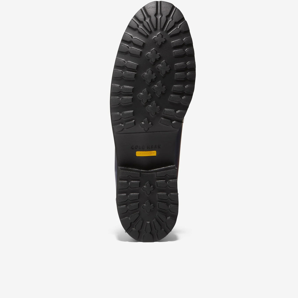 Loafer outsole tread with patterned rubber and small yellow logo label