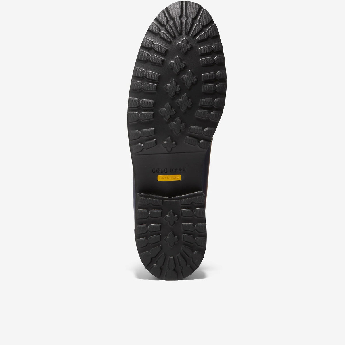 Loafer outsole tread with patterned rubber and small yellow logo label
