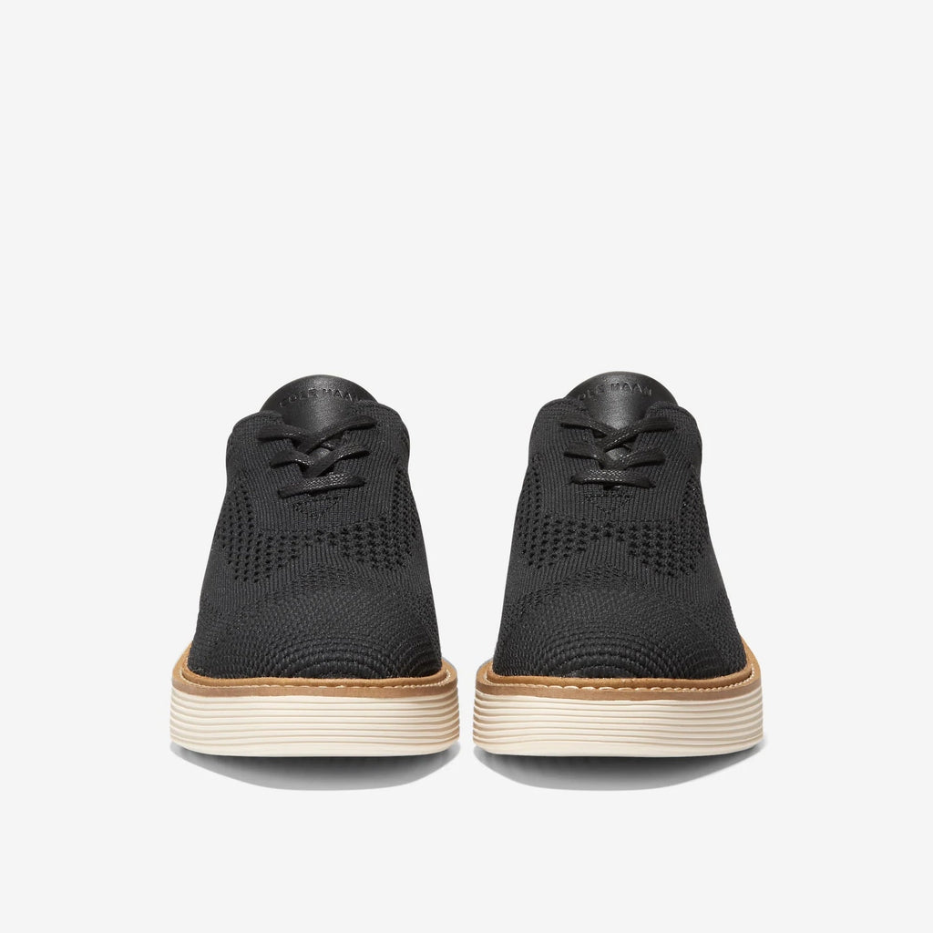 Black lace-up Oxford sneakers with cushioned platform soles, rear view