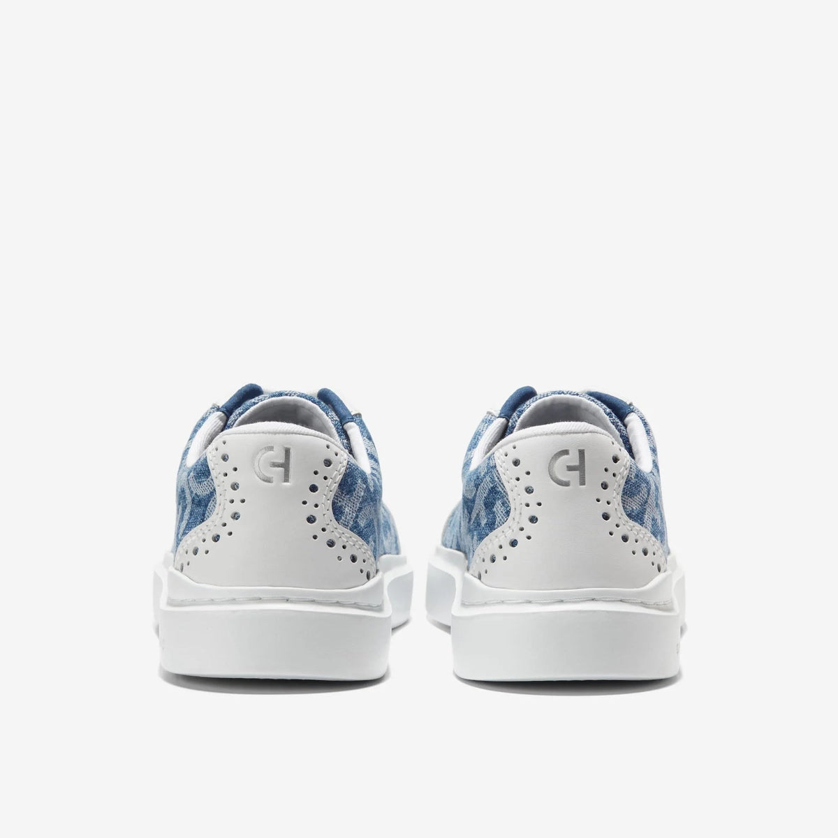 Women's canvas T-toe sneaker back view, white panel with blue patterned heel
