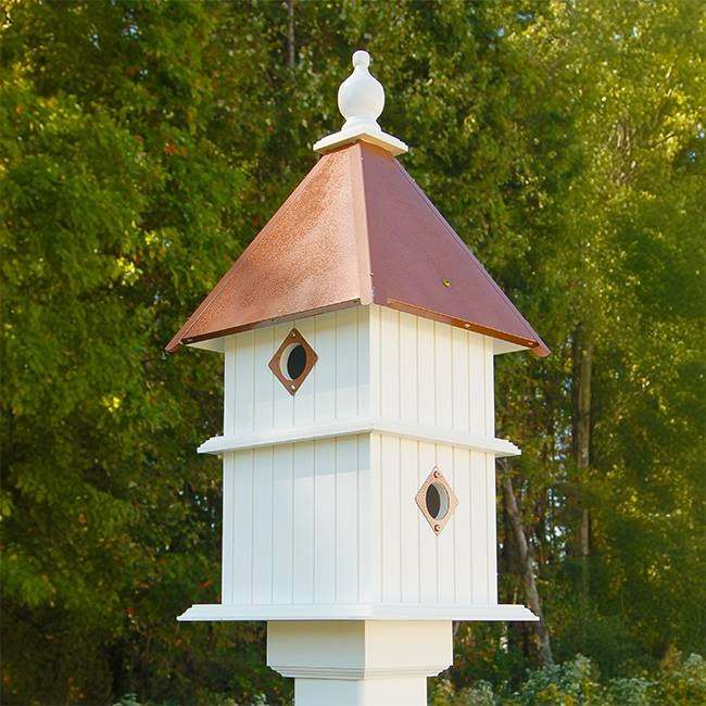 Two-story birdhouse with white-and-light-blue siding, copper-tone roof, two diamond doors