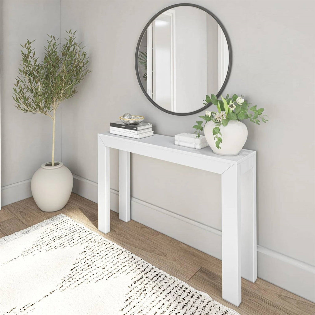 White wooden console table with a slim top and straight legs, shown at an angle.