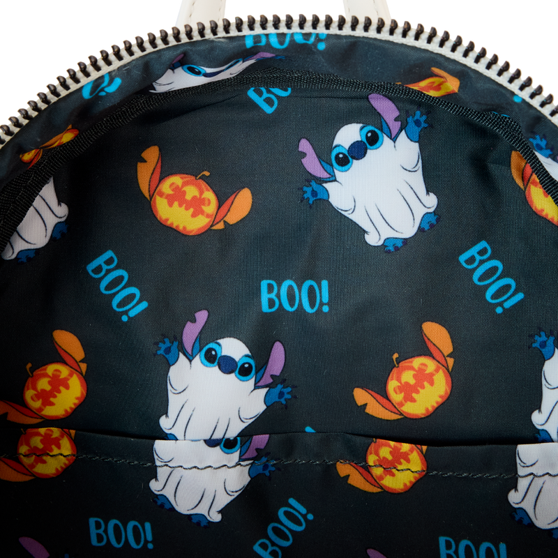 Mini backpack interior lining with dark fabric, Stitch graphics, and repeated “BOO!” text