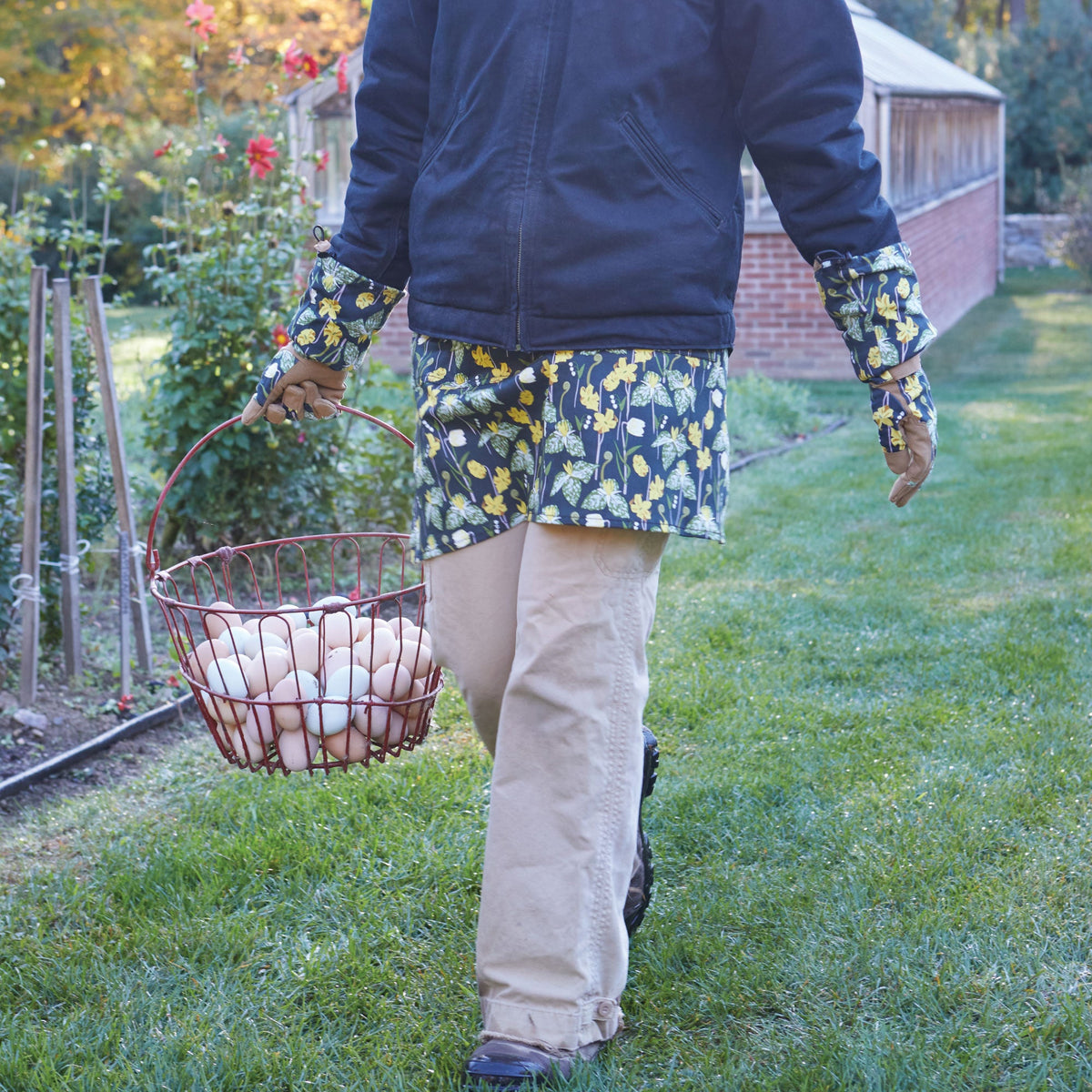 Floral half apron with waist ties, dark blue base with yellow bird-and-flower print