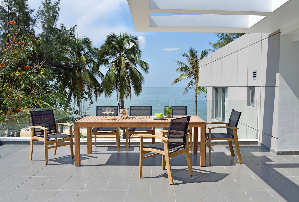 Outdoor dining set with rectangular teak table and black mesh armchairs around it