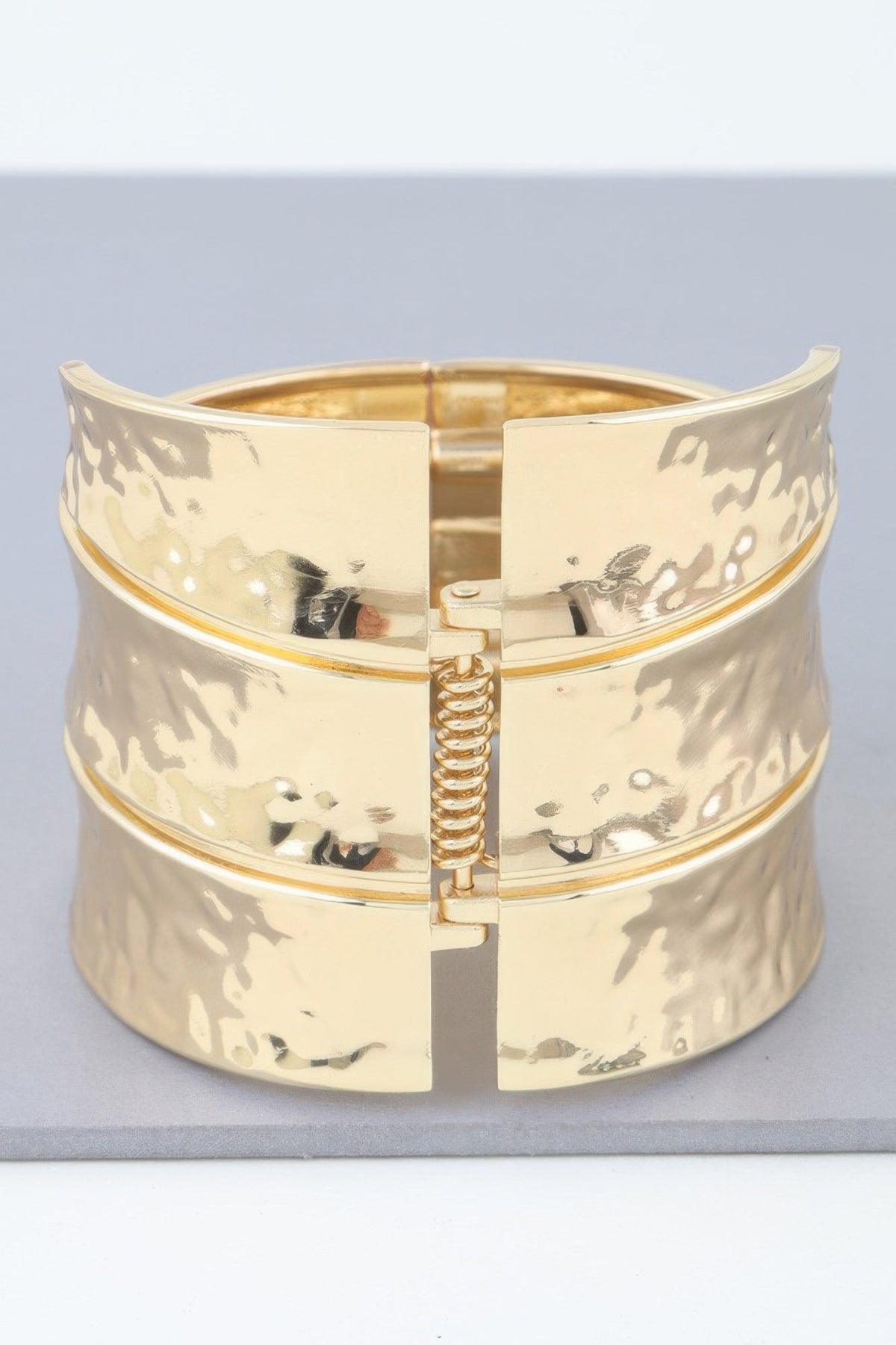 Women's gold-tone wide bracelet cuff with hinged clasp and etched floral/bird details