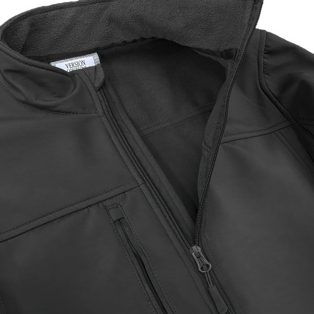 Men's black soft shell jacket close-up: zip front with storm flap and inner lining