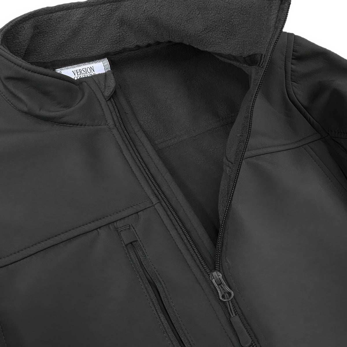 Men's black soft shell jacket close-up: zip front with storm flap and inner lining