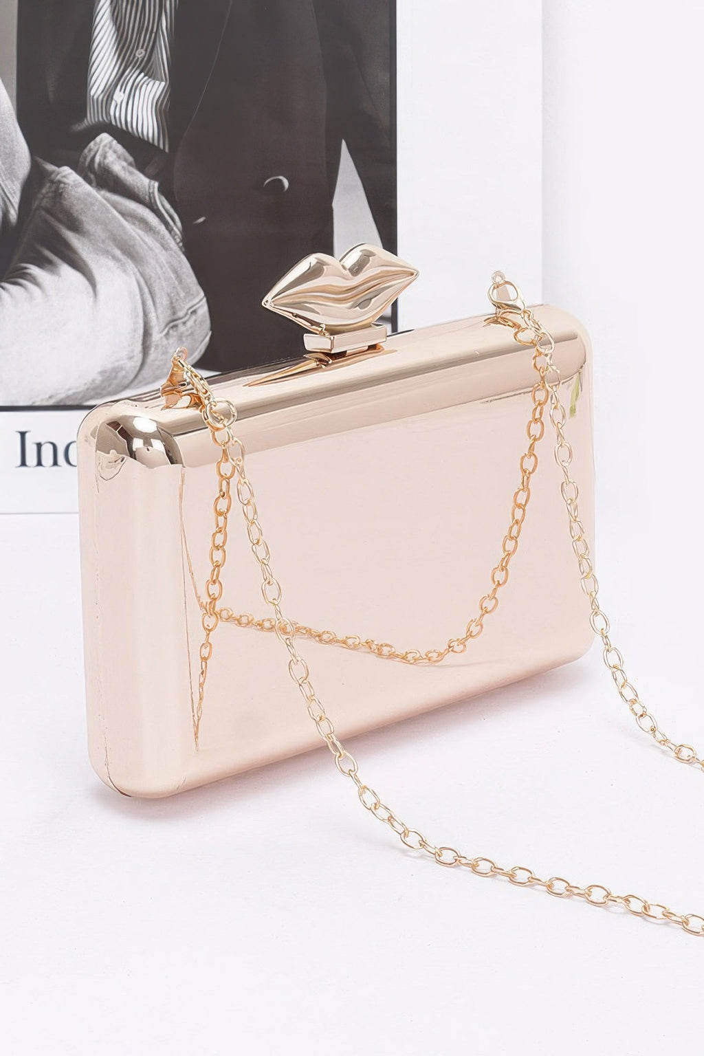 Light beige clutch with gold-tone chain, front flap detail and snap clasp