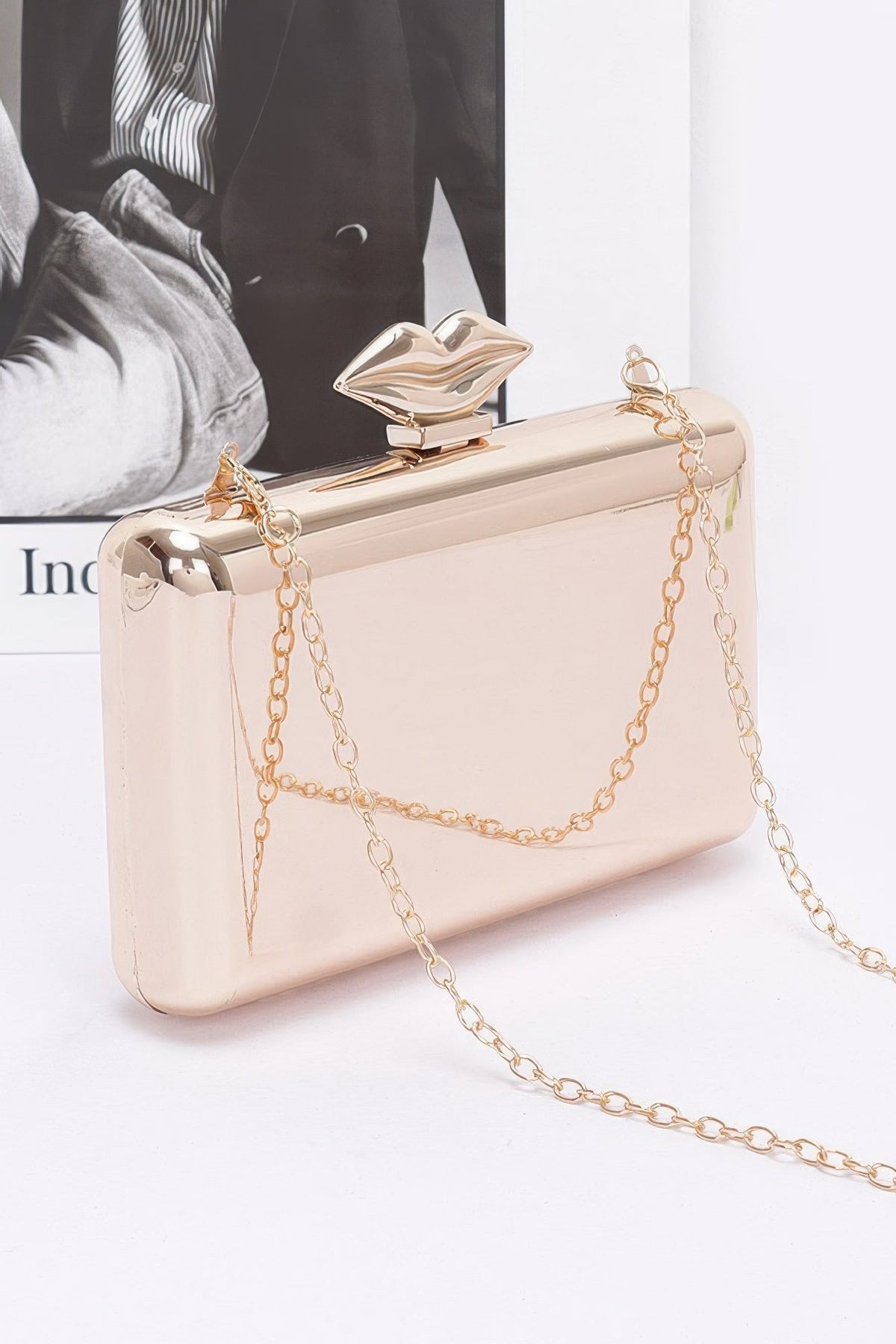 Light beige clutch with gold-tone chain, front flap detail and snap clasp