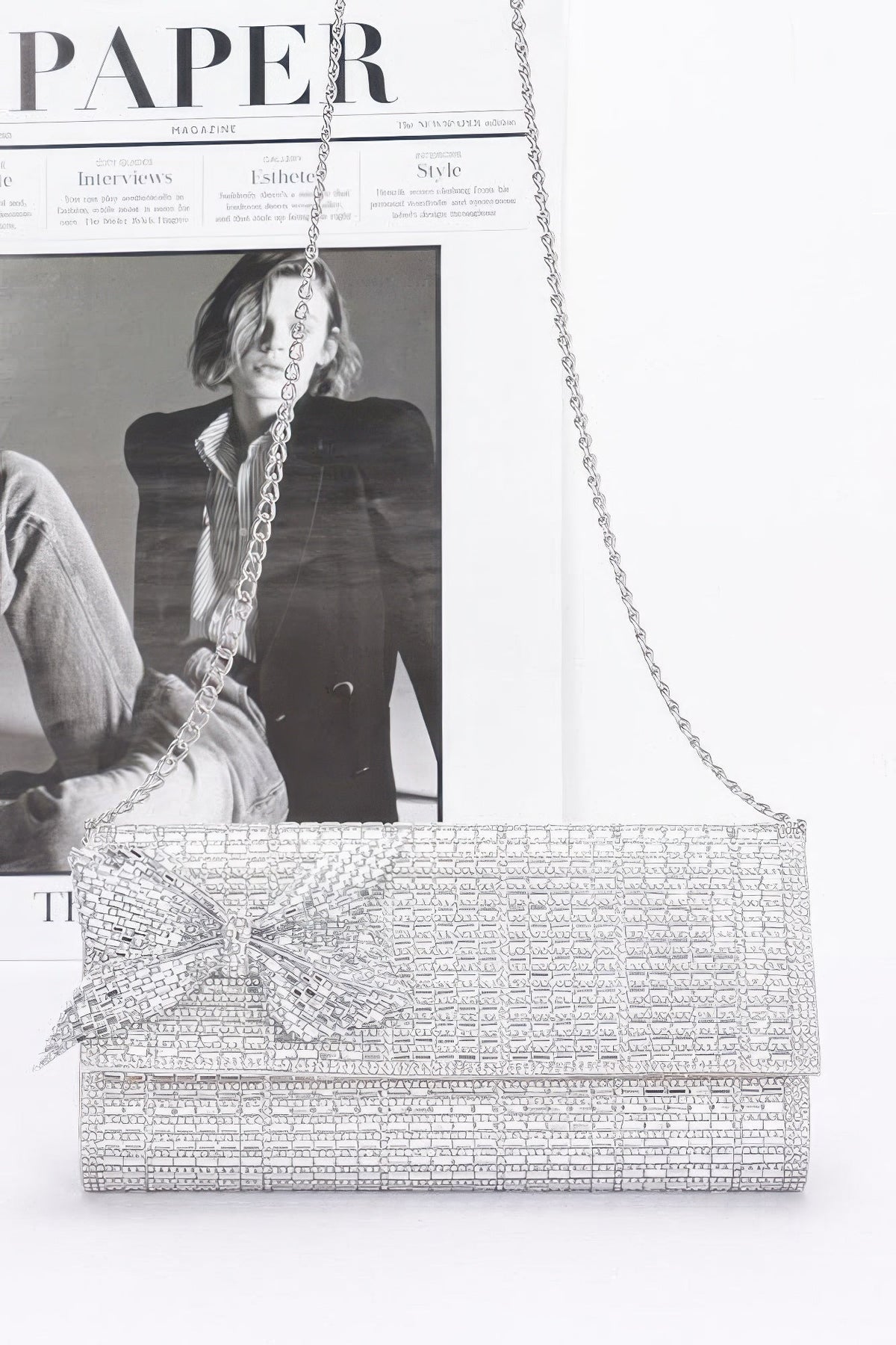 Silver beaded clutch with bow detail and long chain strap